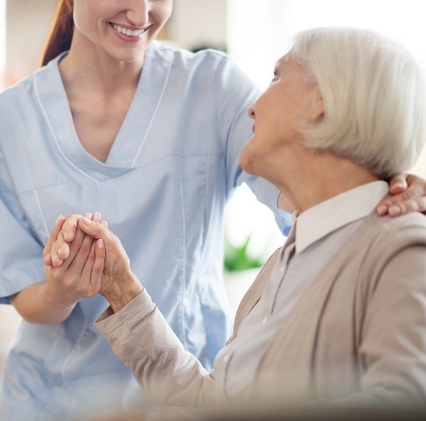 Smiling Caregiver With Senior Person