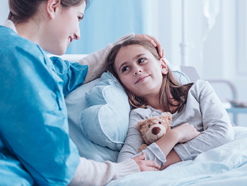Smiling Caregiver Visiting Sick Child
